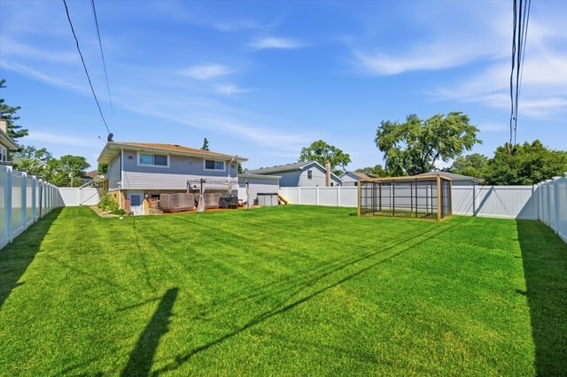 Backyard wide lawn with patio and garden enclosure