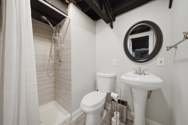 Basement bathroom with shower and pedestal sink