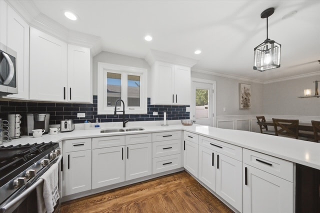 White kitchen cabinets with navy subway tile backsplash